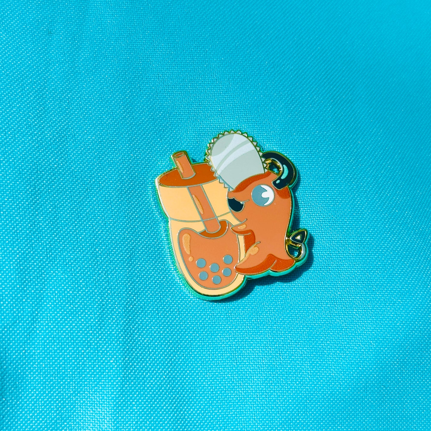 Orange Dog with Chainsaw Hugging Thai Tea Pin