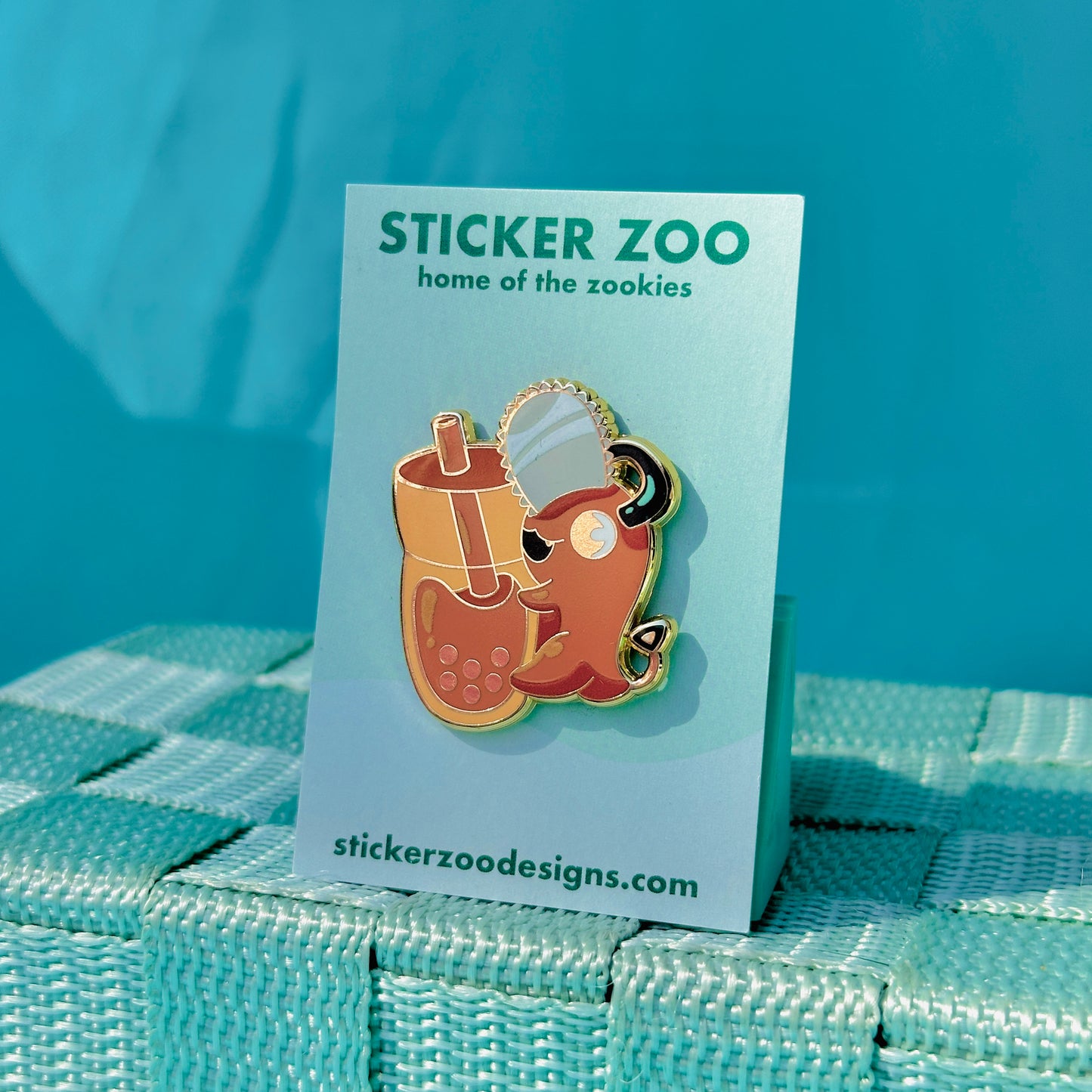 Orange Dog with Chainsaw Hugging Thai Tea Pin