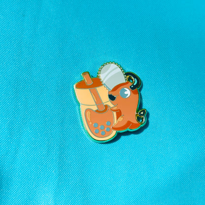 Orange Dog with Chainsaw Hugging Thai Tea Pin